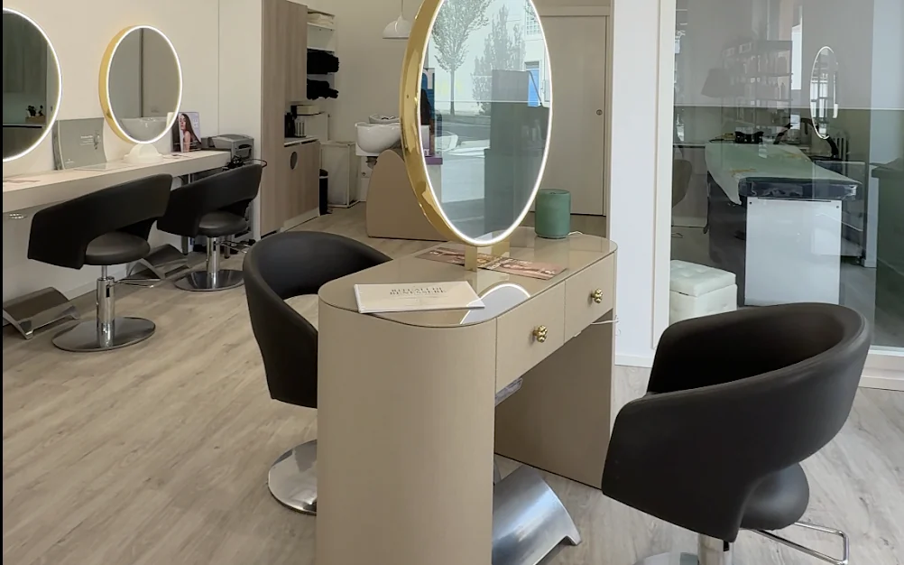 Interno luminoso del salone con postazioni e specchi ovali